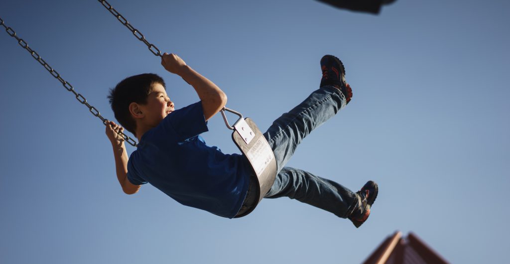 Child on swing KawarthaHaliburton Children's Foundation