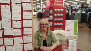A worker sitting at a KHCF booth.