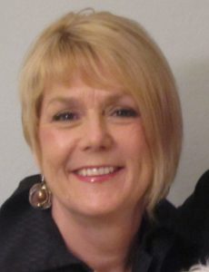 A photo of Donna Berry, facing the camera and smiling.