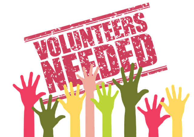 simple drawing of multi colored hands held up with a back ground image stating volunteers needed