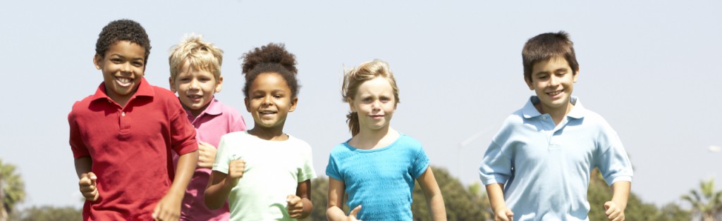Children running in the park and playing soccer