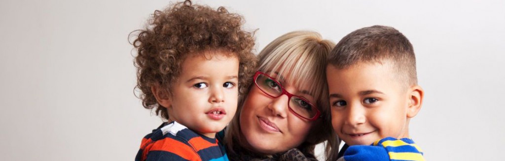 mother with two children smiling at the camera