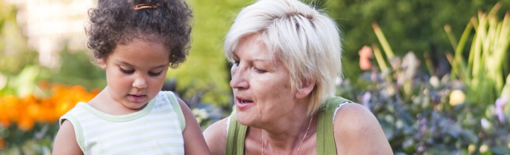 Woman and her grand daughter working in the garden