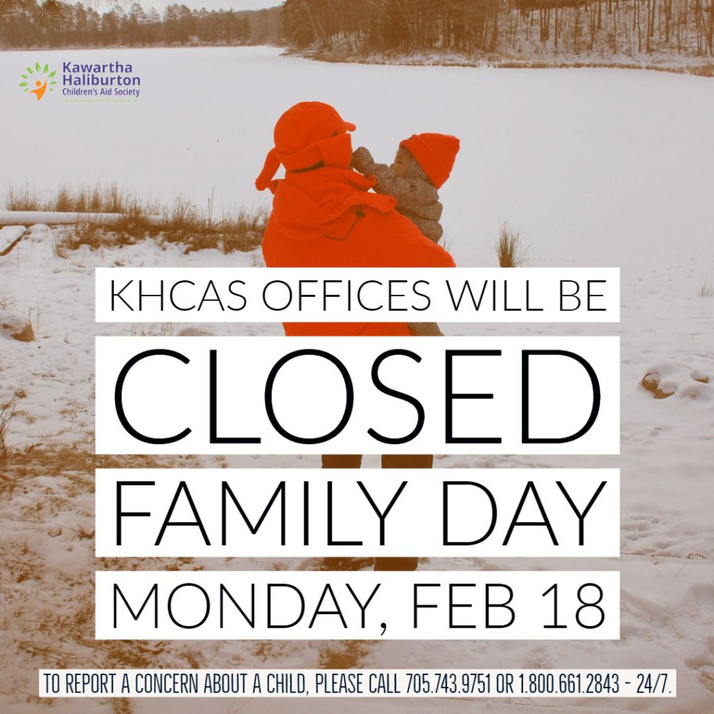 child being held by adult in winter scene